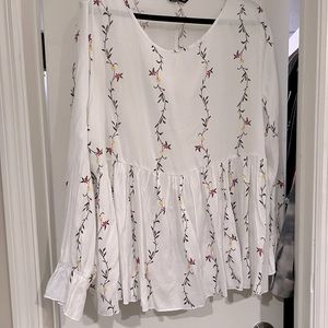 White flowered empire waist style blouse.